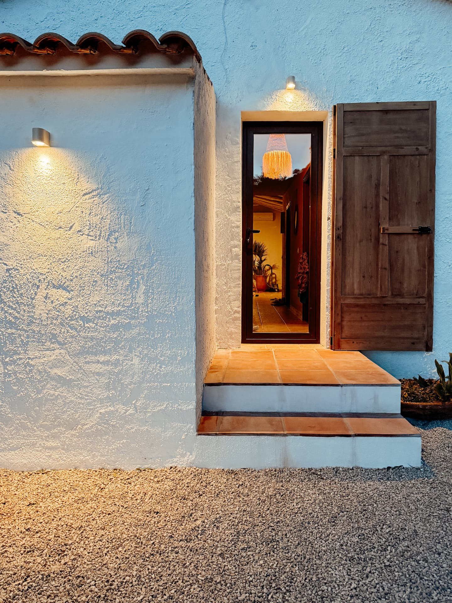 Back door of Casa Lomi opening onto the garden at dusk