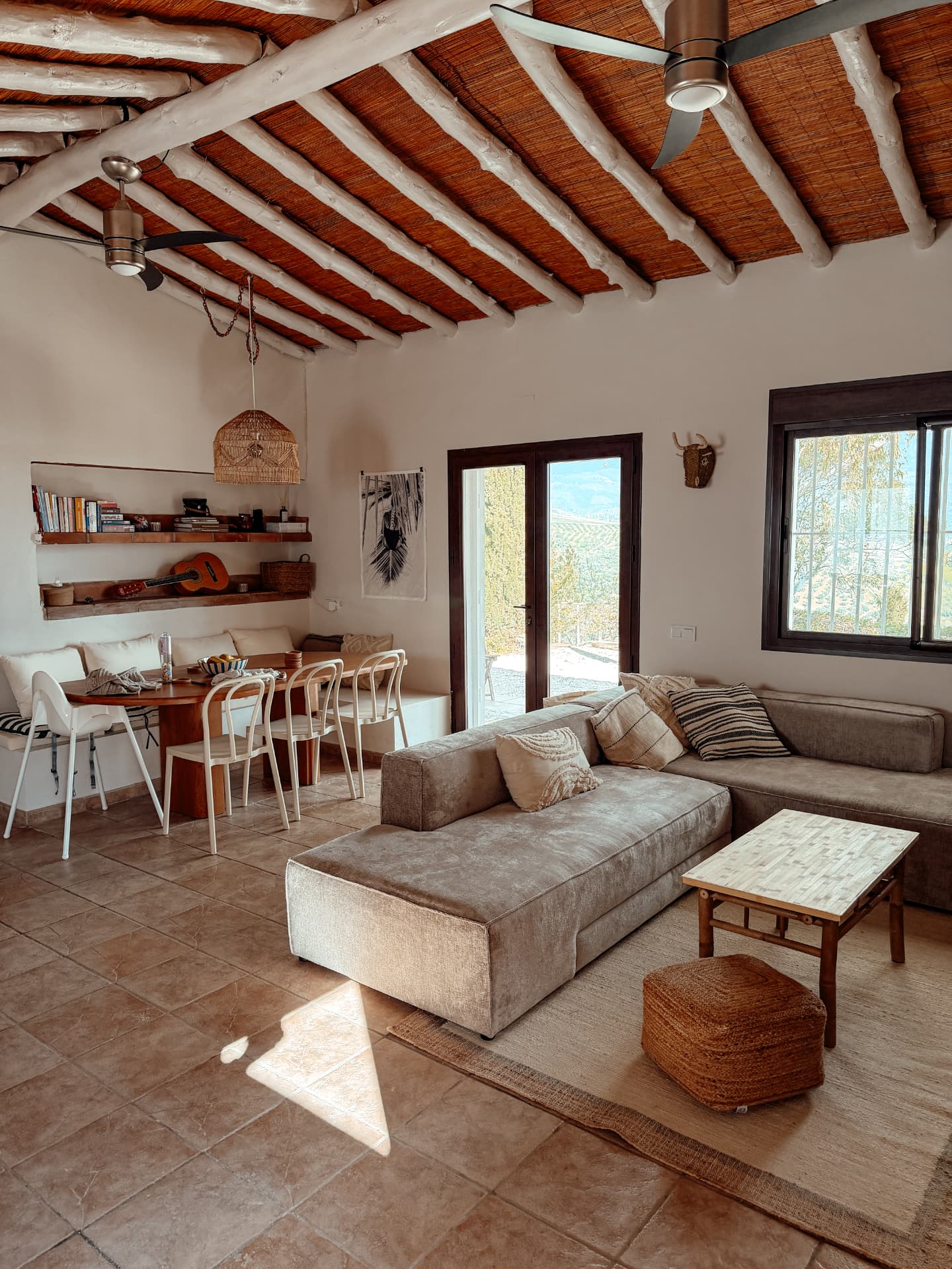 Bright living room with bamboo ceiling, sofas and mountain views