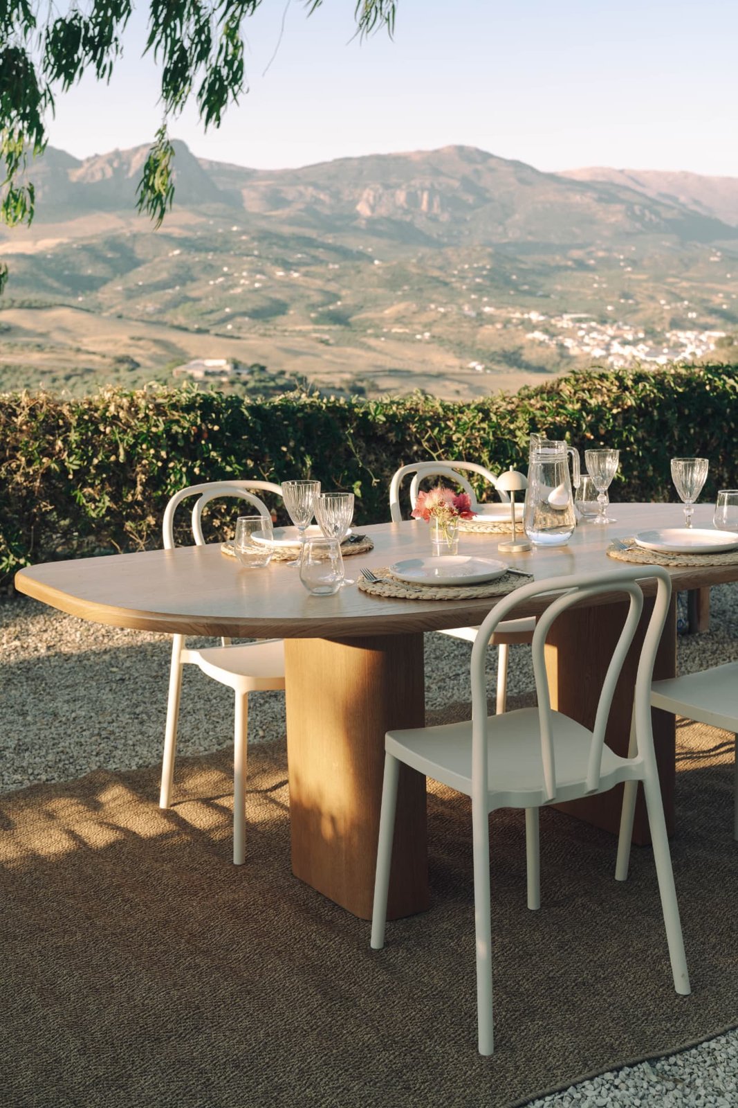Outdoor dining table set for dinner with the Andalucian mountains behind