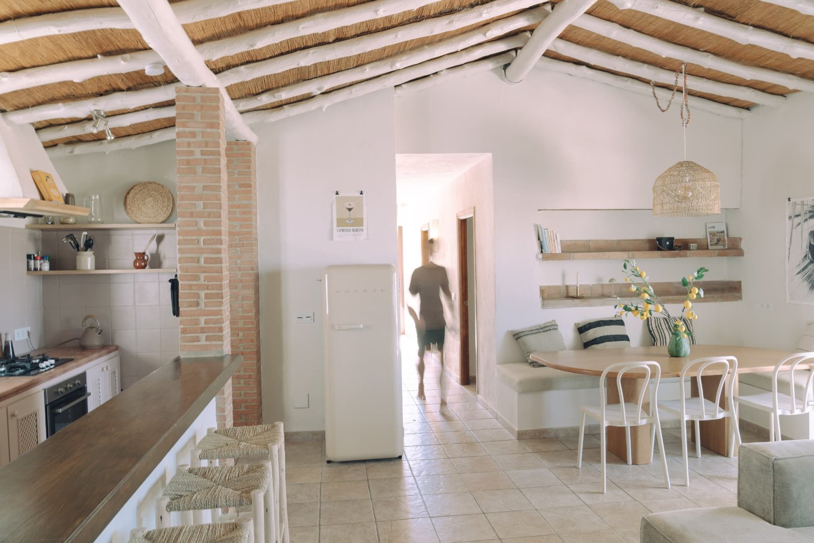 Open living room and kitchen with cane ceiling and dining nook